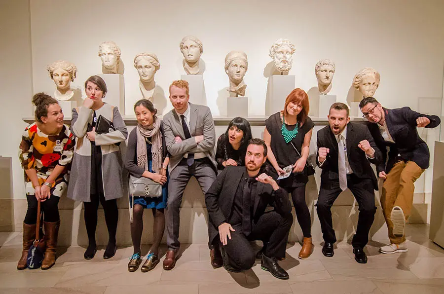 A VIP group poses with the art.