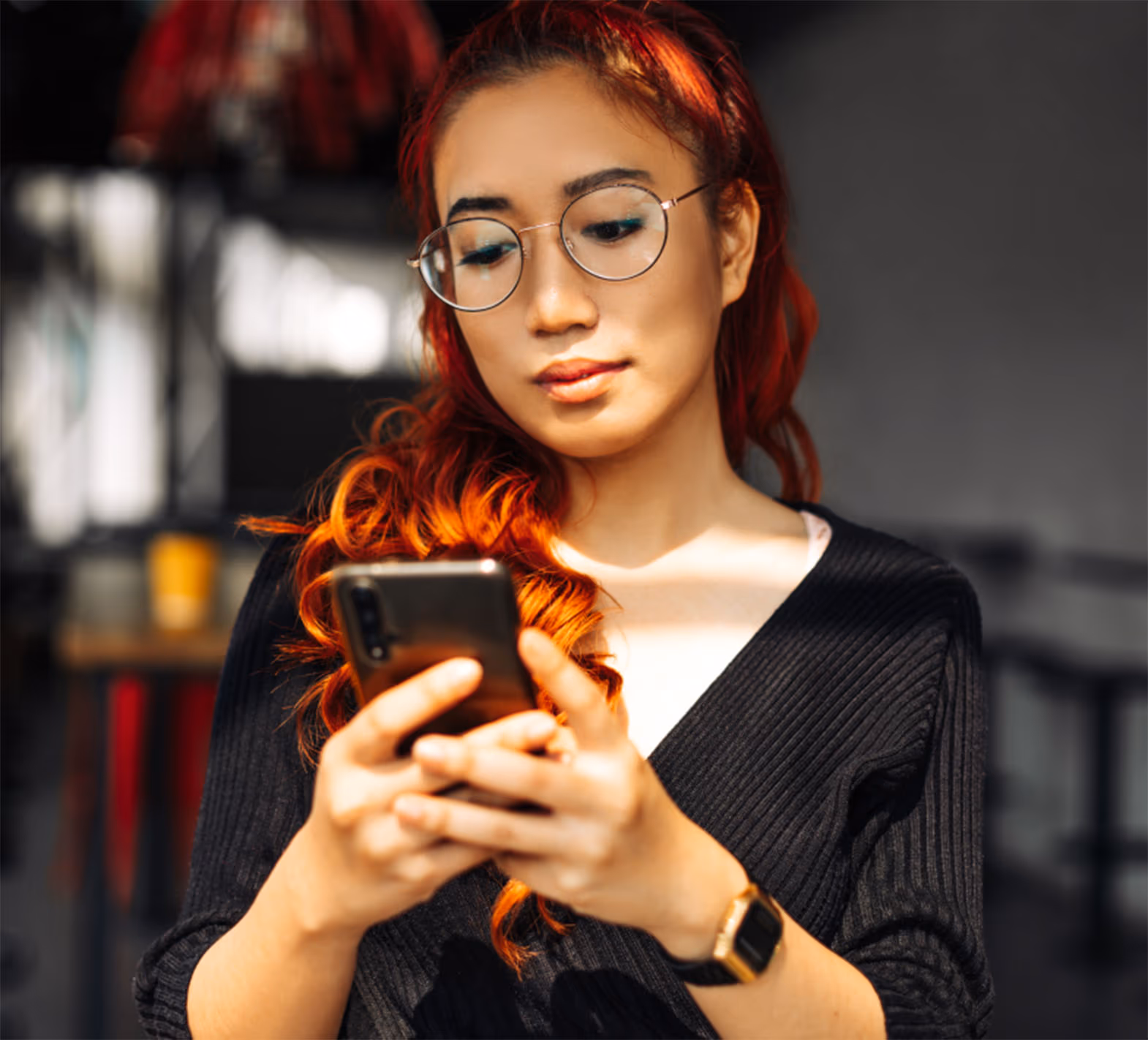 Person with glasses using a smartphone