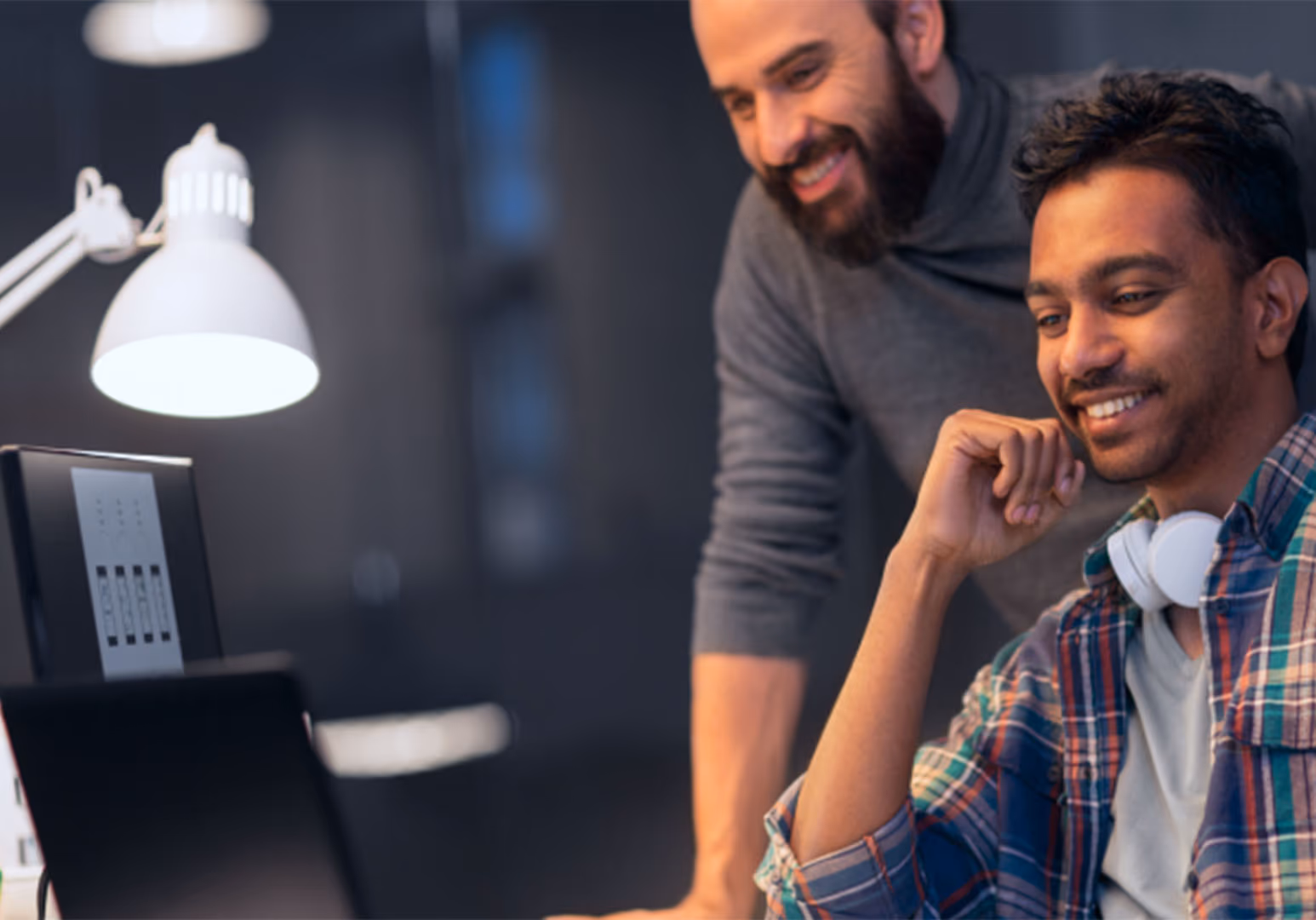 Two people looking at desktop