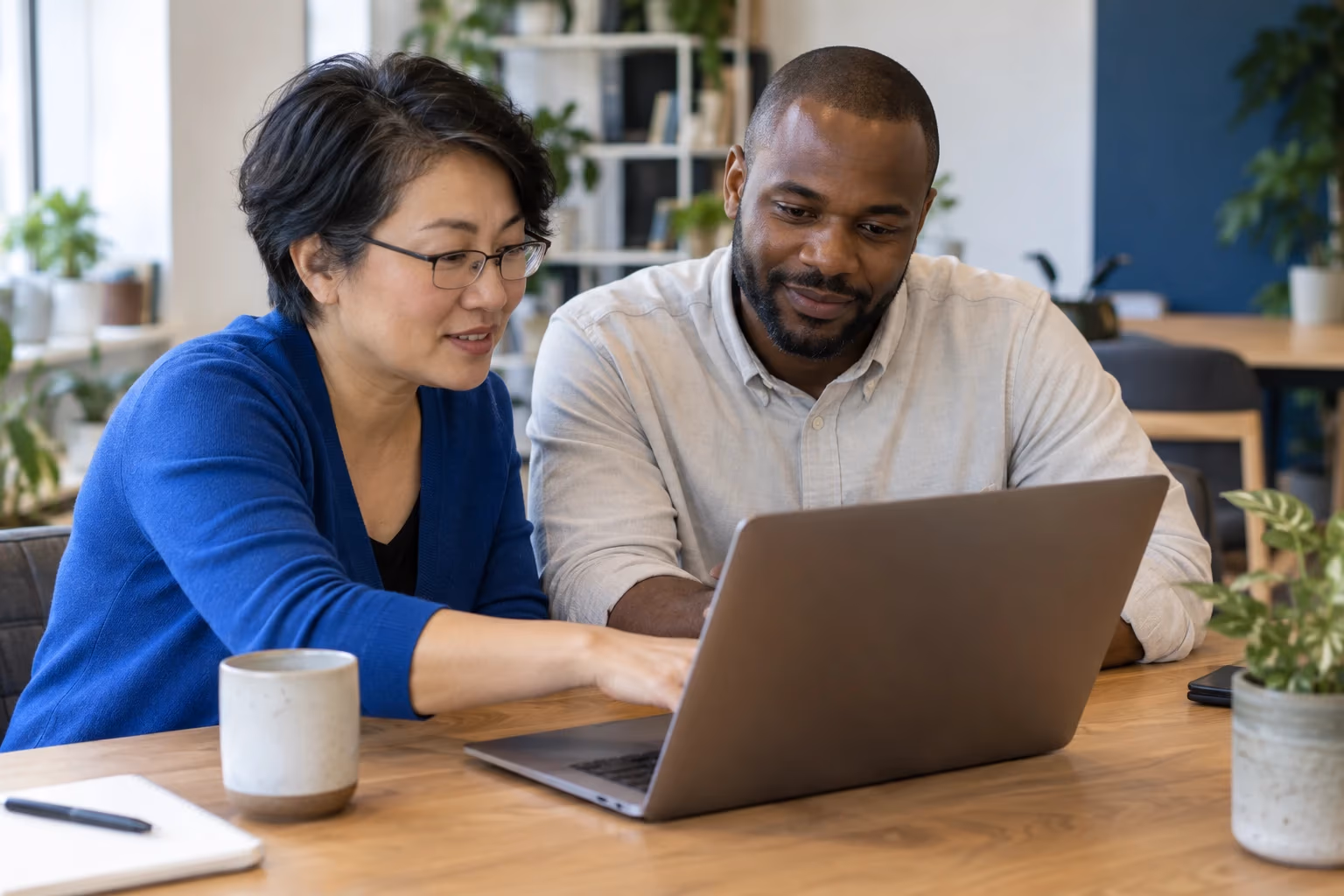 Two colleagues working through a website question together