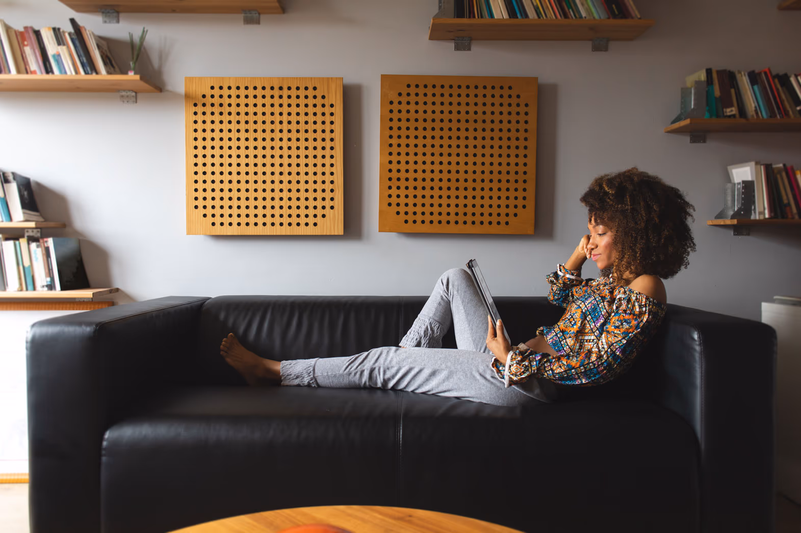 woman in brown shirt admires tablet