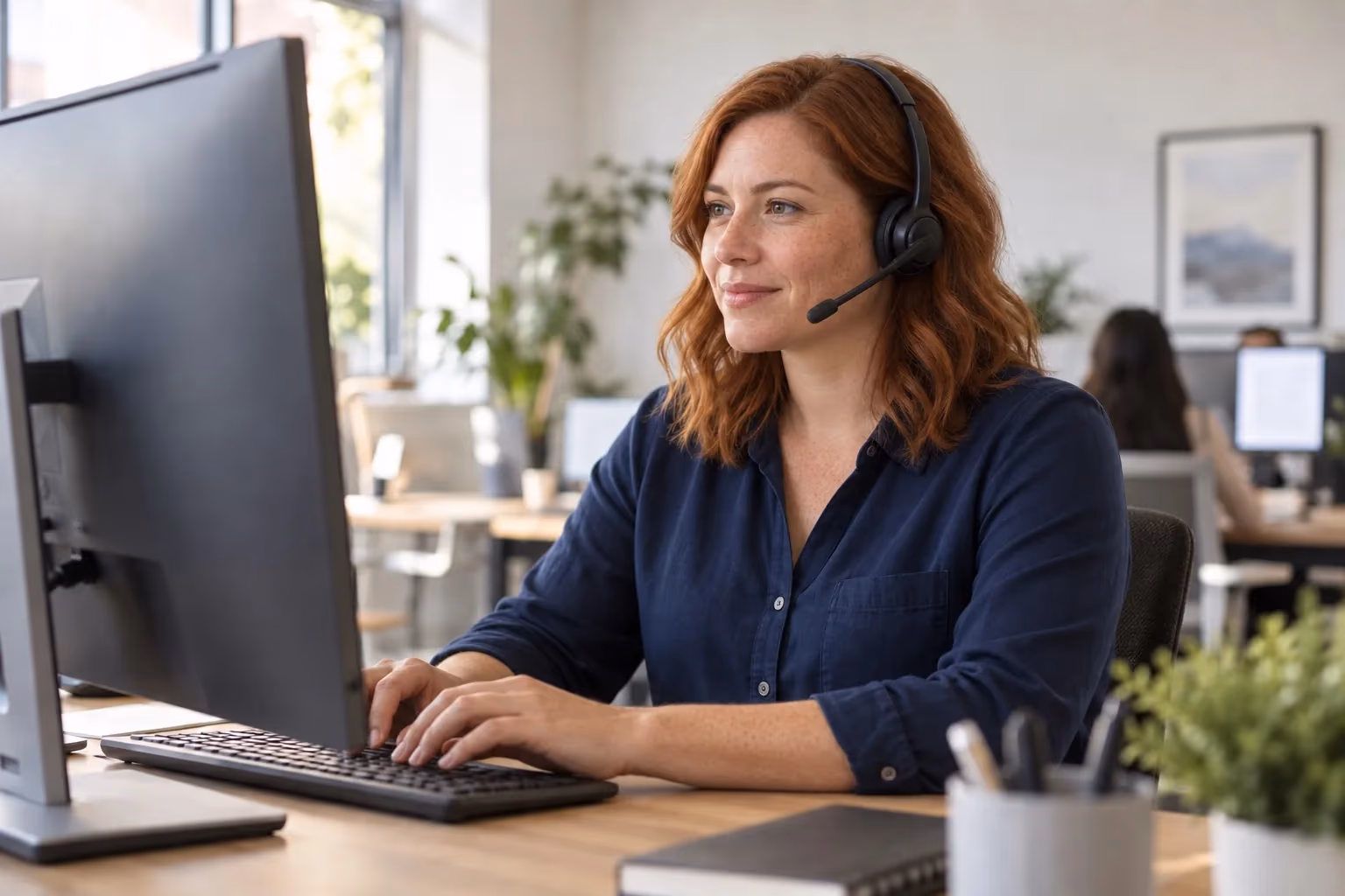 Illustrative support professional listening while working at a computer
