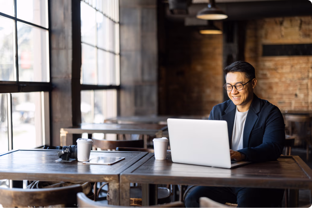 smiling man using laptop