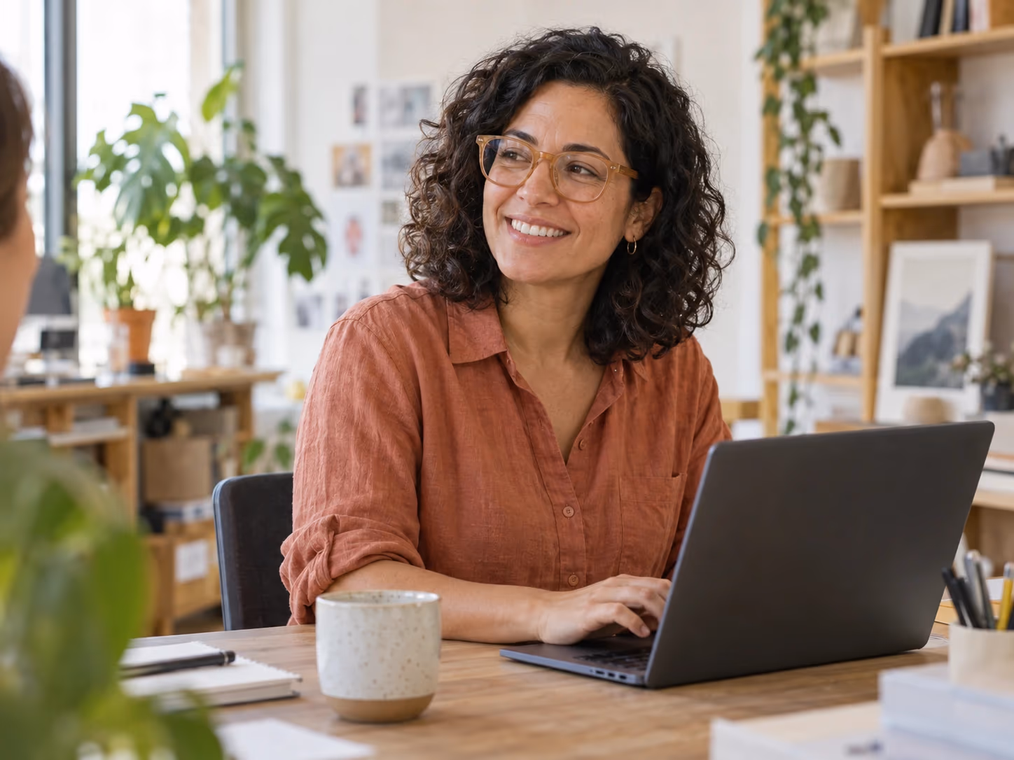 A small-business owner working on her website in a bright studio